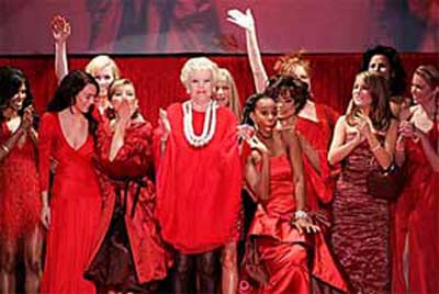 Female musical artists celebrate the conclusion of The Heart Truths Red Dress Collection 2006 Fashion Show on the runway at Olympus Fashion Week.  Wearing red dresses designed by Americas top fashion houses including Amerie for Tommy Hilfiger (far left), Elaine Stritch for Charles Nolan (center left), Kelly Rowland for House of Dereon (center right), and Nelly Furtado for Betsey Johnson (far right).