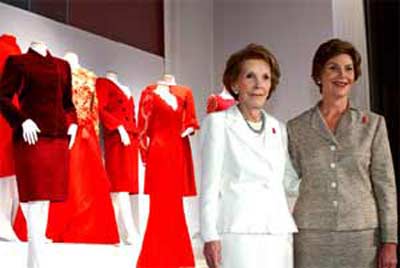 Heart Truth ambassador Mrs. Laura Bush (right) and former First Lady Nancy Reagan (left) commemorate the unveiling of the First Ladies Red Dress Collection at the John F. Kennedy Center for the Performing Arts.  The display features red dresses and suits donated from all seven of America's living First Ladies in support of The Heart Truth.