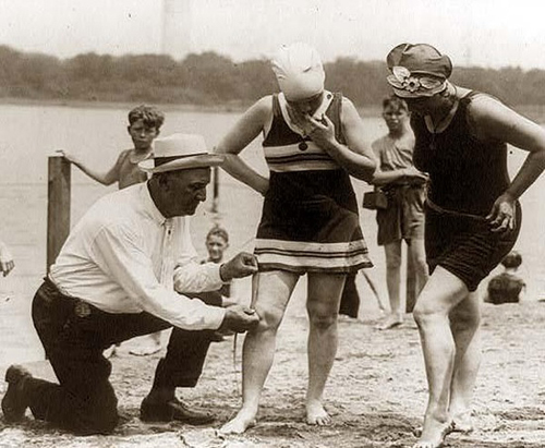 Measuring bathing suits in the early 1920s. 