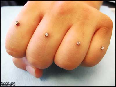 Diamonds piercing each finger of hand