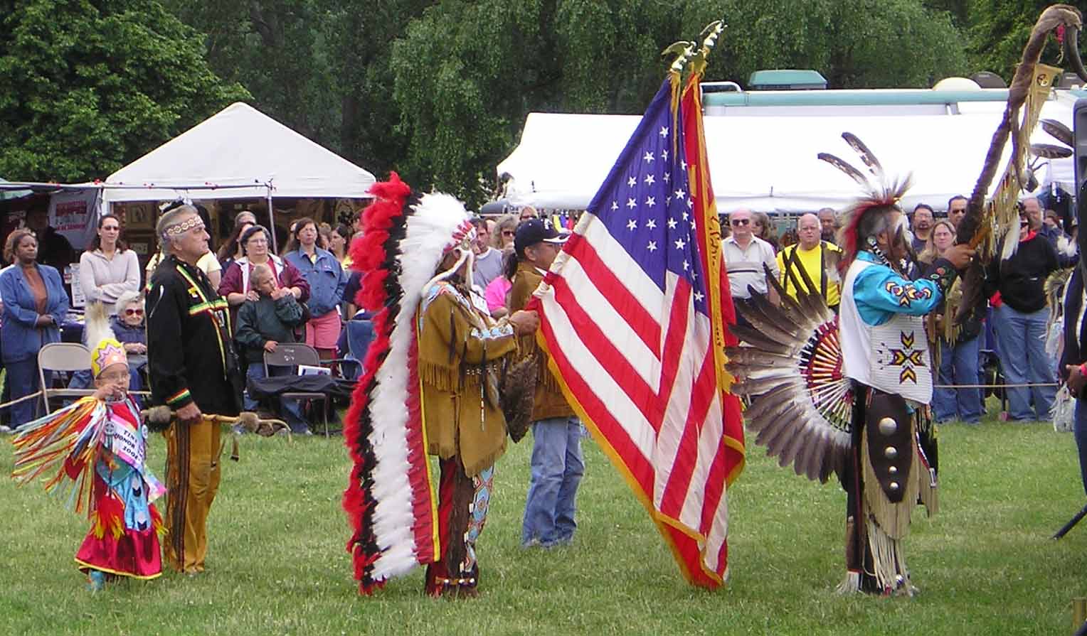 American Indians at Cleveland Powwow holding flag