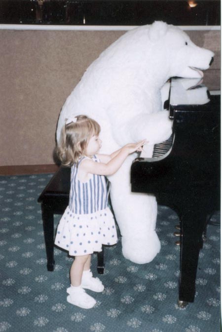 Arianna Korting at 2 years old trying to play piano in a hotel lobby in Chicago
