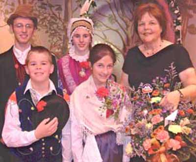 Cecilia Dolgan and children in traditional Slovenian costumes