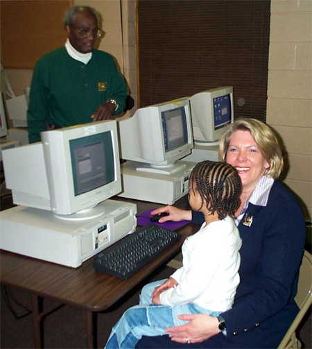 Jane Campbell with volunteer Ken Eskridge of Computers Assisting People at a new community computer lab on Kinsman