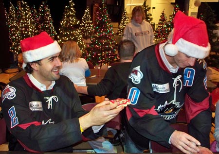 Lake Erie Monsters hockey players Wes O'Neill and Darren Haydar help kids make Christmas cookies