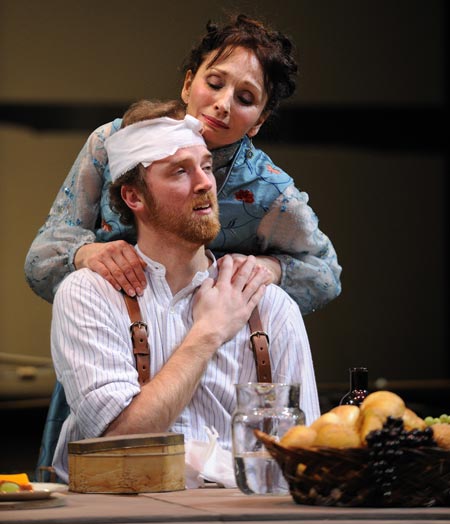 A mother (actor Laura Perrotta as Arkdina) embraces her son (actor Kevin Crouch as Trplev) in Great Lakes Theater Festival's production of Chekhov's soaring classic The Seagull at the Hanna Theatre, PlayhouseSquare.
