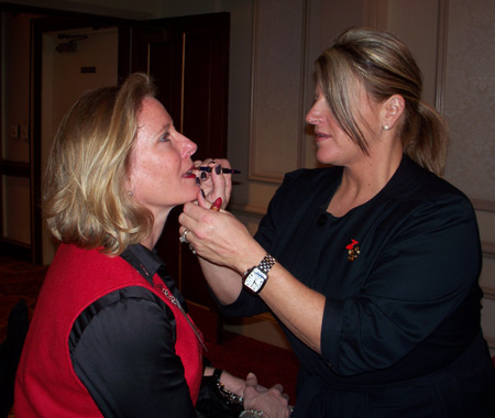 Lina Bellanti of Estee Lauder (Macy's) applies lip liner to Ruth Ann Resparc 