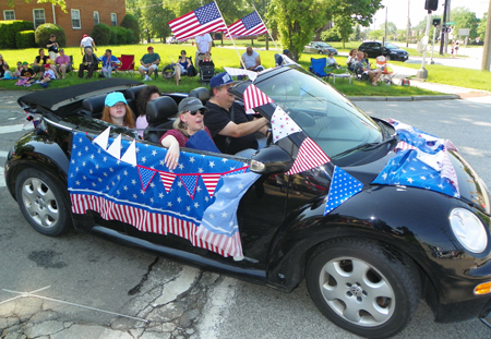 Car with flags in parade
