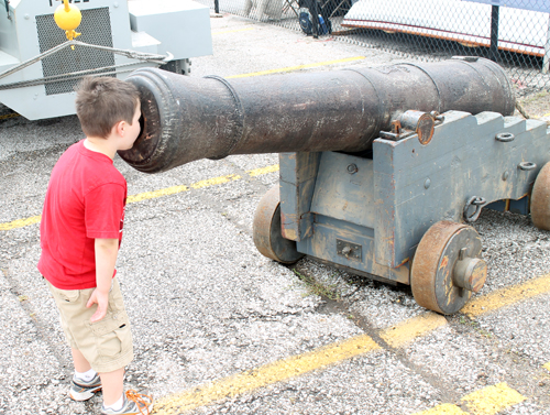 Boy looking into Cannon at Tall Ships Festival in Cleveland