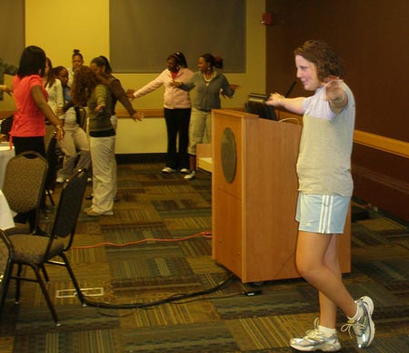 Ann from JCU leads high school girls in a fitness break