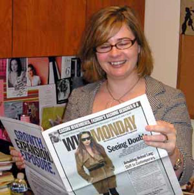 Kim Crow ewading the paper doing research