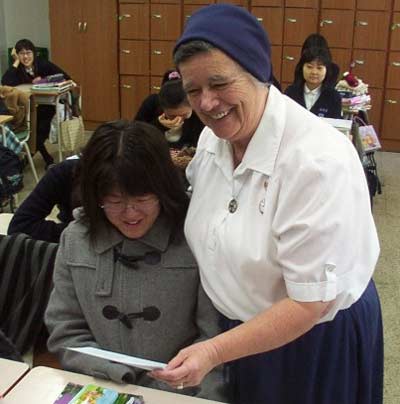 Sister Ann Patrick teaching a Korean girl
