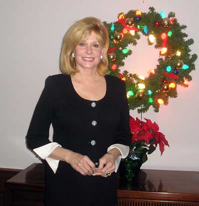 Wilma Smith in front of Christmas wreath
